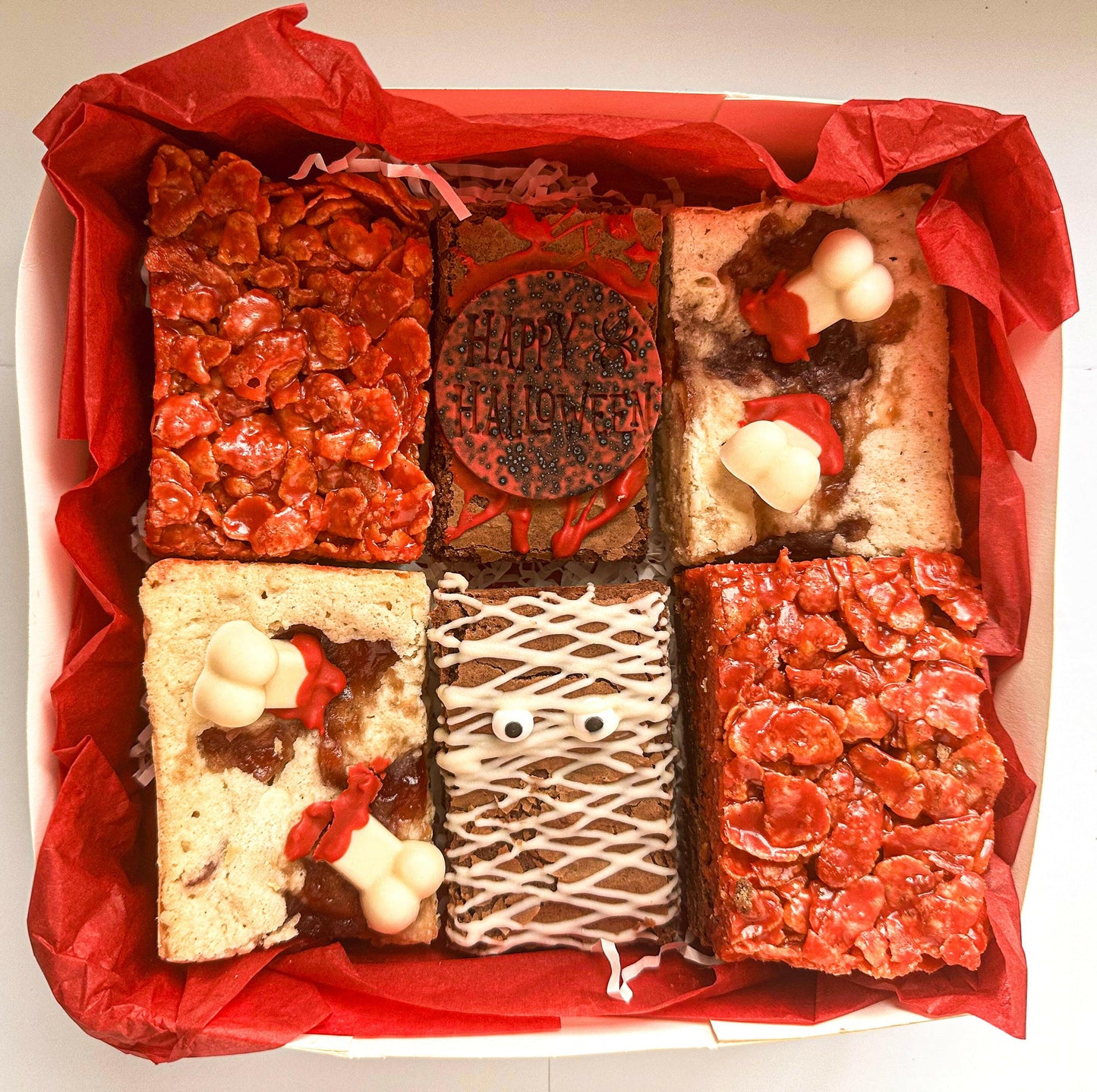 A Halloween-themed cornflake brownie, studded with crunchy cornflakes and drizzled with a spooky caramel sauce, perfect for a hauntingly delicious treat.